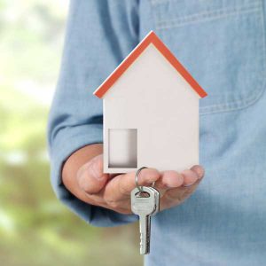 Person holding house and keys